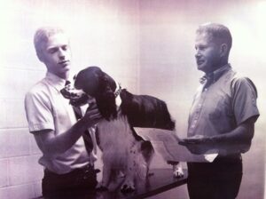two men and dog